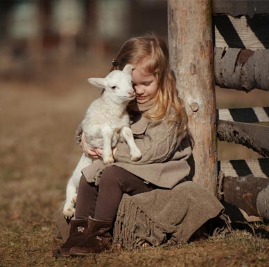 Girl with a baby lamb