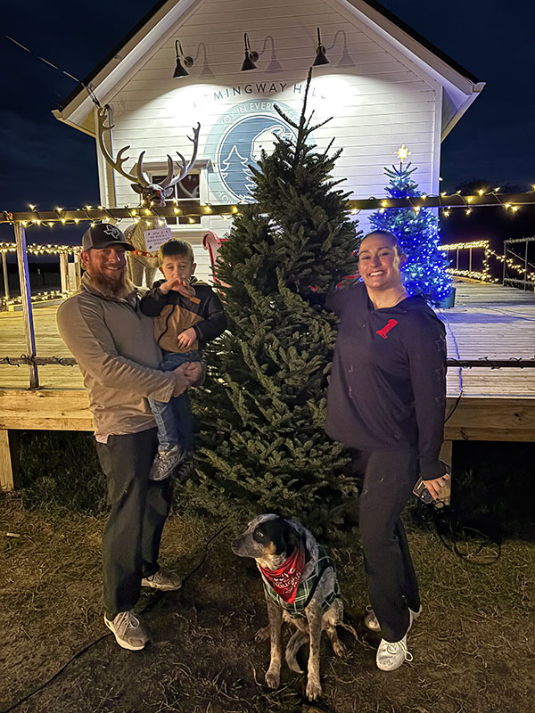 Family buying a fresh cut Christmas tree at Hemingway Hill